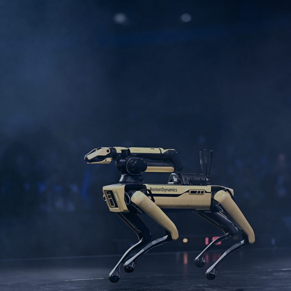 Quadruped robot walking on a darkened stage