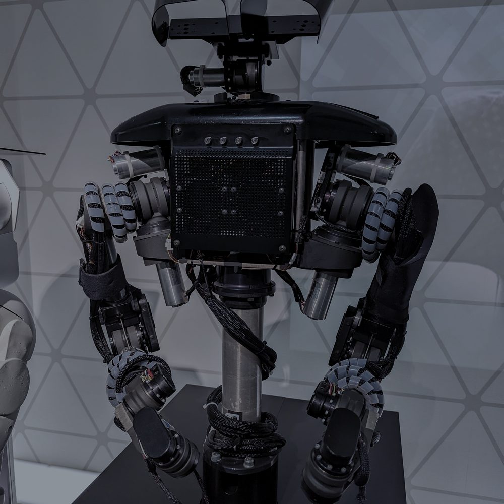 Close-up of a humanoid robot’s twin arms and sensor head